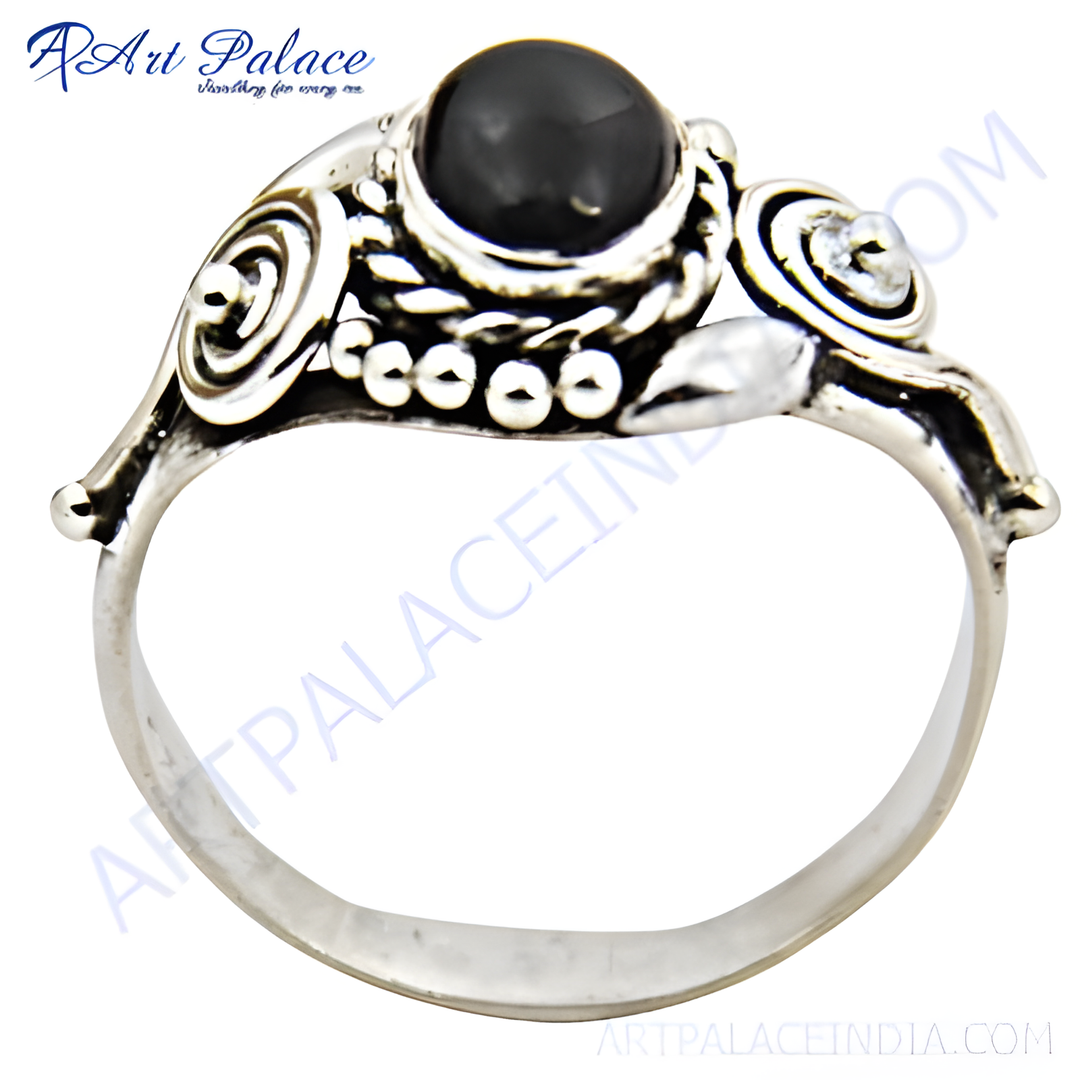 Sterling silver ring featuring a round black onyx gemstone set in a detailed design.
