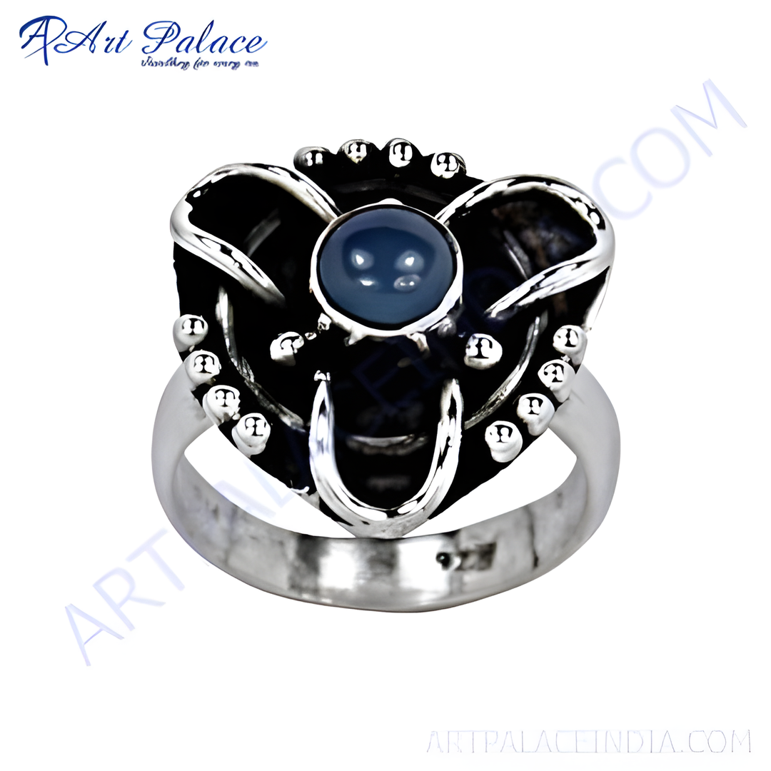 Sterling silver statement ring with a large blue gemstone center stone and unique design
