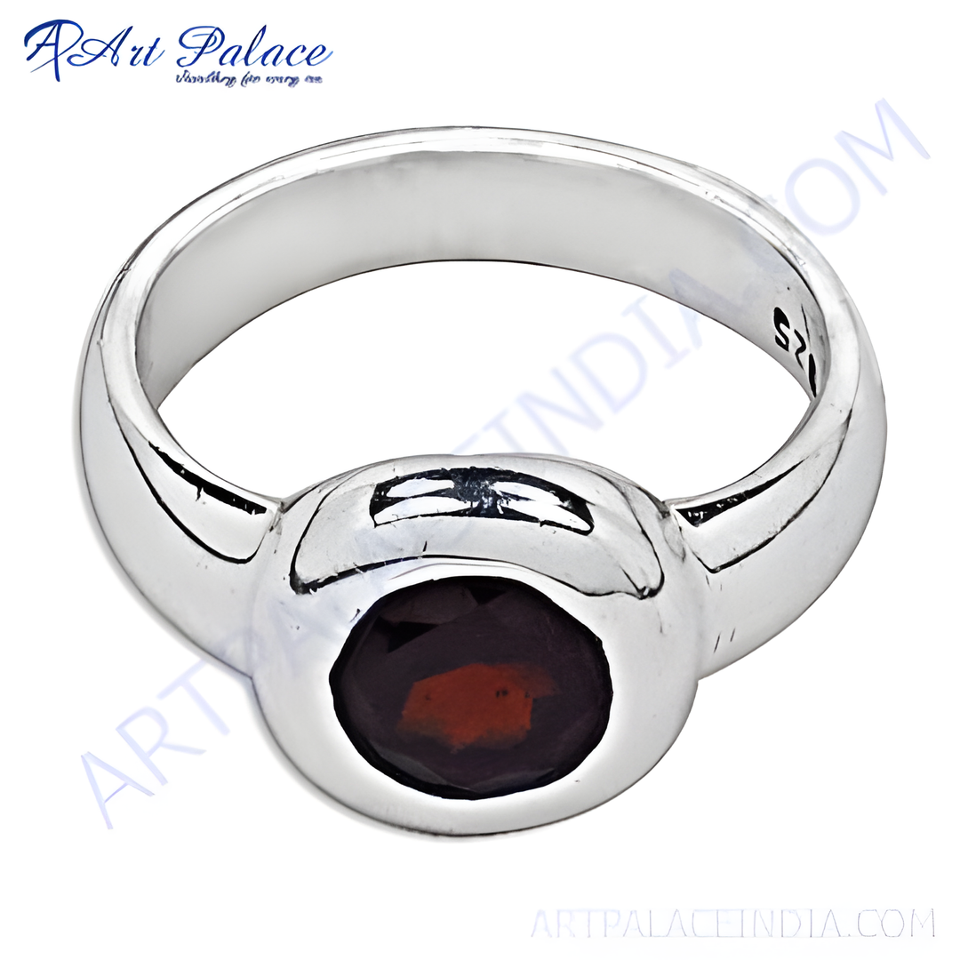Sterling silver ring with a vibrant red oval-cut garnet gemstone.