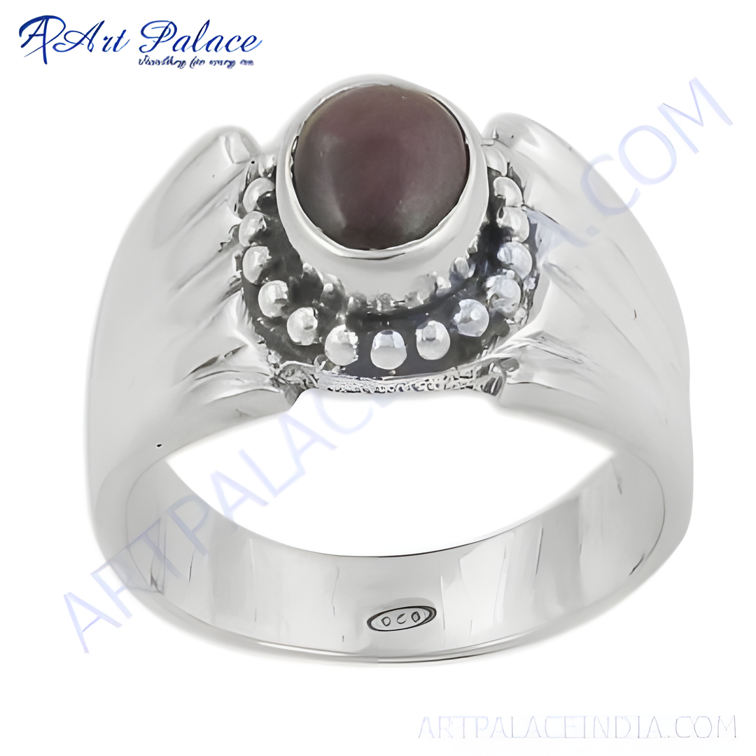 Sterling silver ring with a dark gemstone, showcasing the ring's intricate details and polished finish.