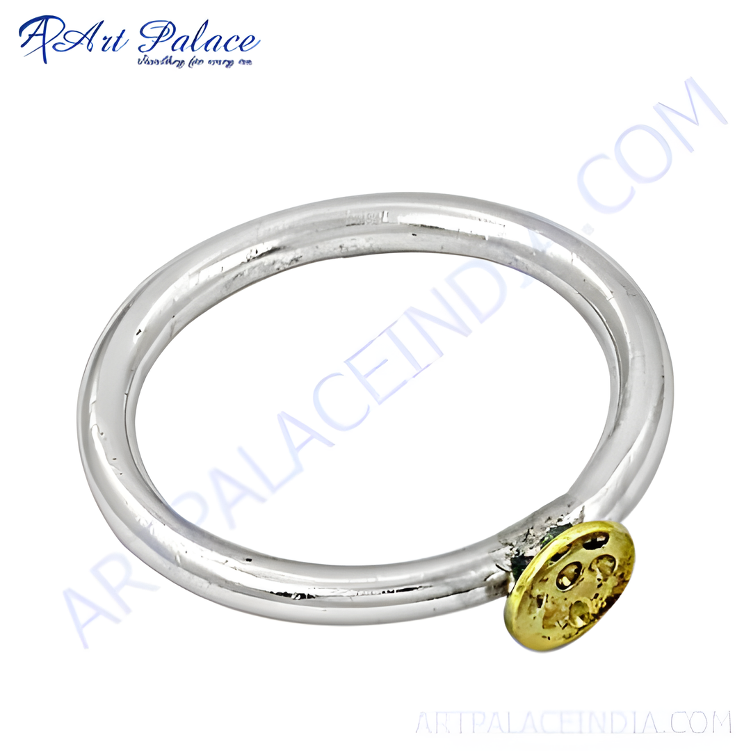 Sterling silver ring with a gold detailing, perfect for everyday wear. Simple yet elegant design.