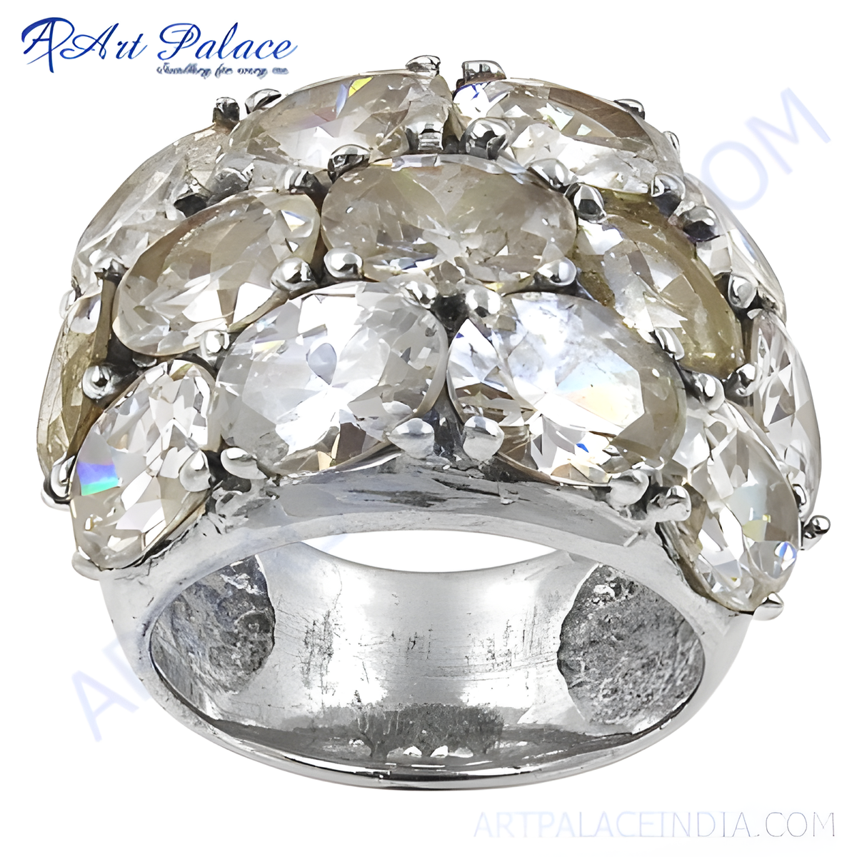 Close up of a silver ring with many champagne colored gemstones