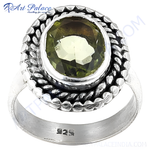 Load image into Gallery viewer, Sterling silver ring with a large, round green peridot gemstone, showcasing a detailed design around the stone.
