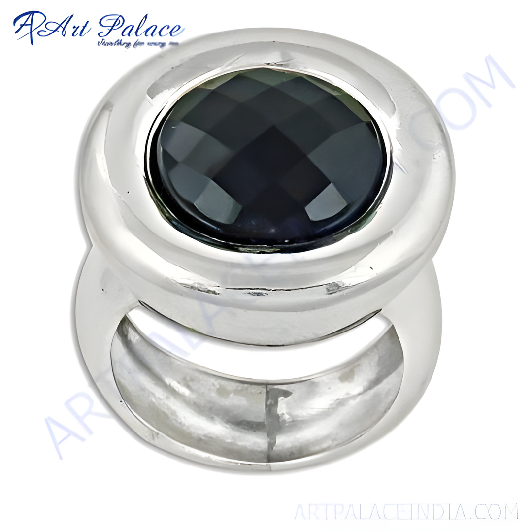 A silver ring with a large, faceted black gemstone set in a polished silver band.