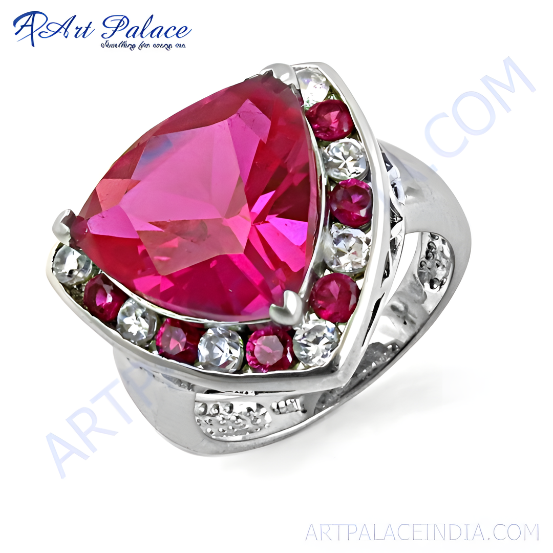 Sterling silver ring featuring a large trillion-cut ruby gemstone with surrounding accent stones, a vibrant red color