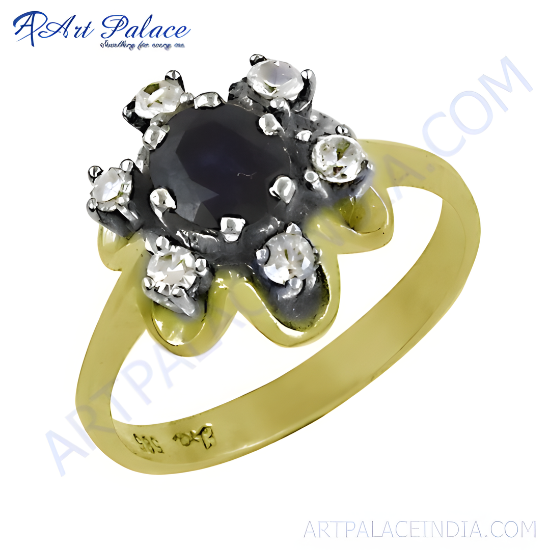 gold plating floral ring with a central dark blue sapphire surrounded by diamonds.