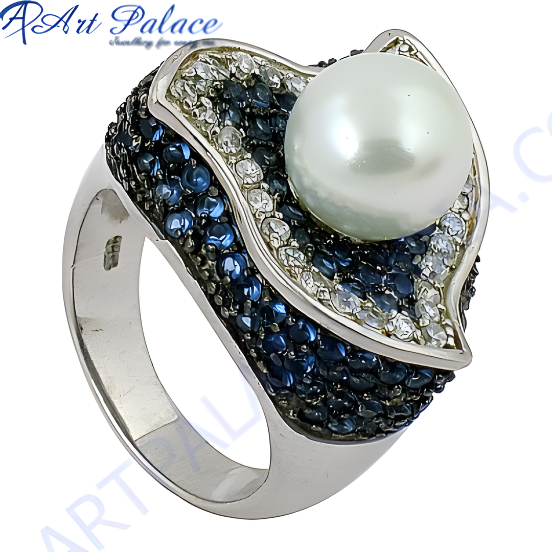 Sterling silver ring featuring a large white pearl and blue gemstone accents.