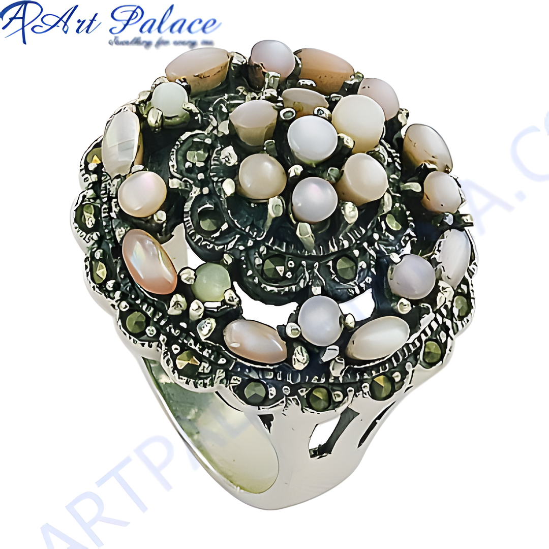 Sterling silver cocktail ring featuring mother of pearl gemstones and marcasite detailing on a white background.