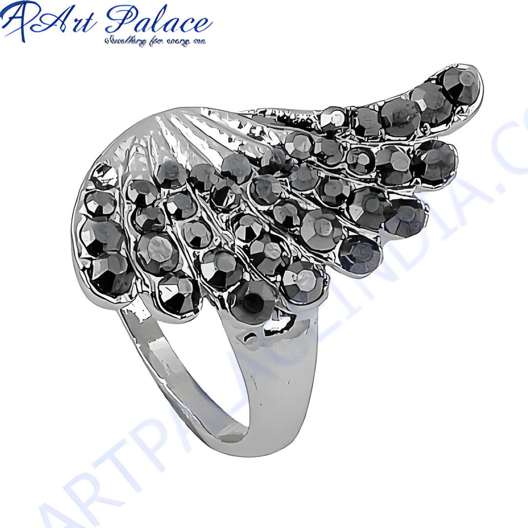 Silver wing ring with a black gemstone design, perfect for a bold fashion statement.