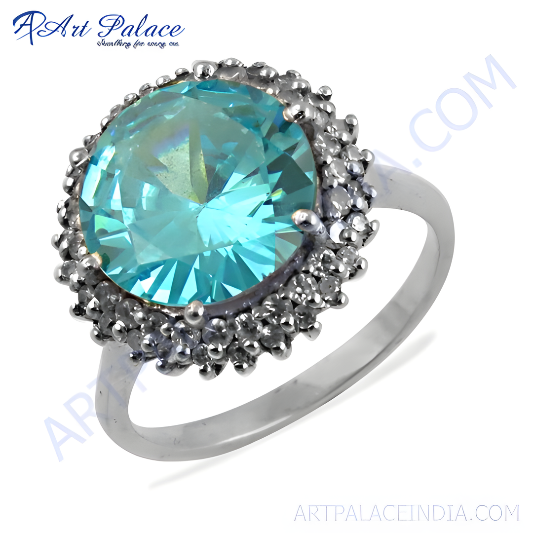 Silver halo ring featuring a large, brilliant-cut aquamarine gemstone surrounded by smaller accent stones.