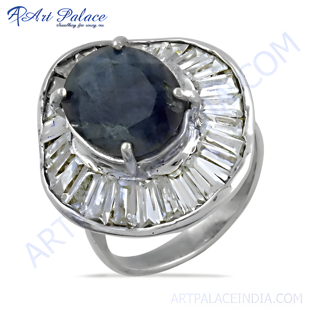 Sterling silver cocktail ring featuring a dark blue sapphire center stone and white CZ accents.