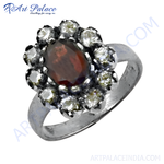 Load image into Gallery viewer, Sterling silver floral ring with a central garnet gemstone and surrounding cubic zirconia.
