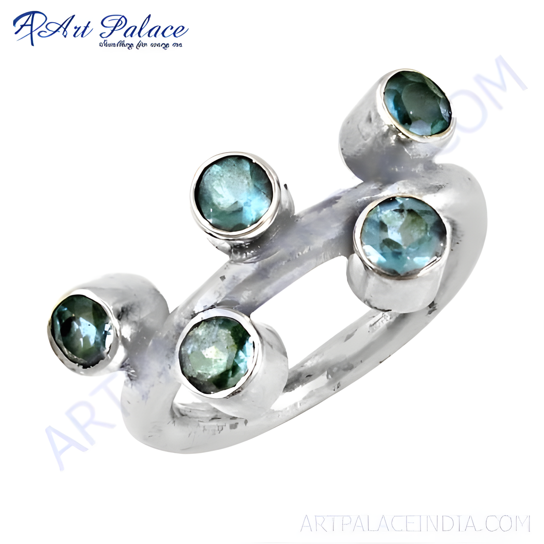 Sterling silver ring featuring multiple round blue topaz gemstones, set in a unique modern design.