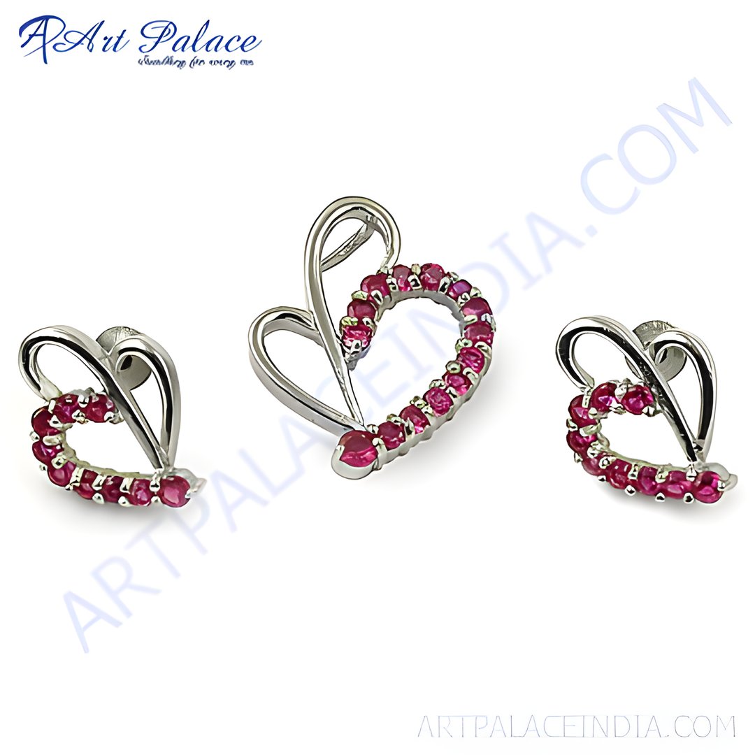 Sterling silver heart shaped jewelry set with ruby gemstones, a pendant and earrings.