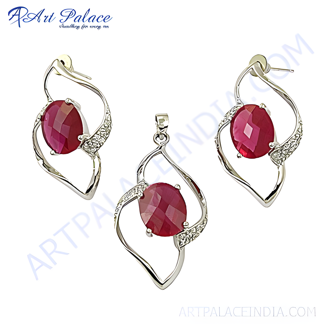 Silver ruby jewelry set with oval cut red ruby gemstone pendant and matching earrings.