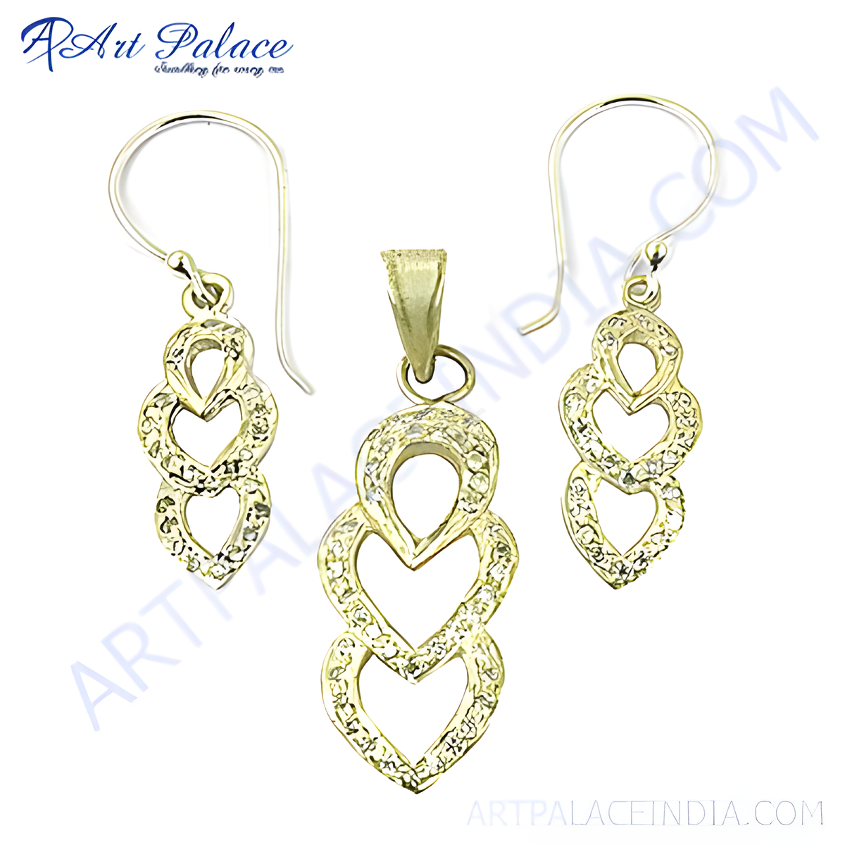 Gold pendant and earrings set with crystal heart design on white background