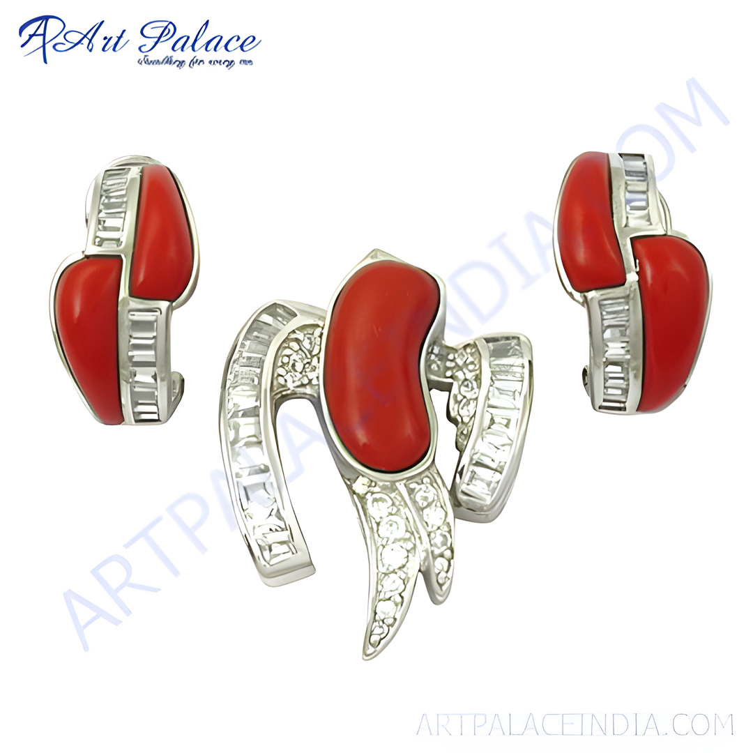 Sterling silver jewelry set with red coral gemstones, including a pendant and matching earrings.