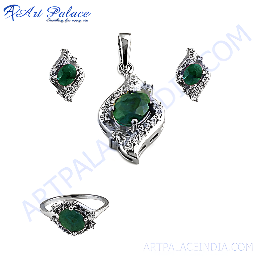 Sterling silver emerald jewelry set featuring a pendant, earrings, and ring with green gemstone centers.