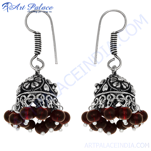 Silver jhumka earrings with ornate design and dangling red beads for women
