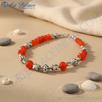 Load image into Gallery viewer, Red gemstone beaded necklace with silver accents on a black background
