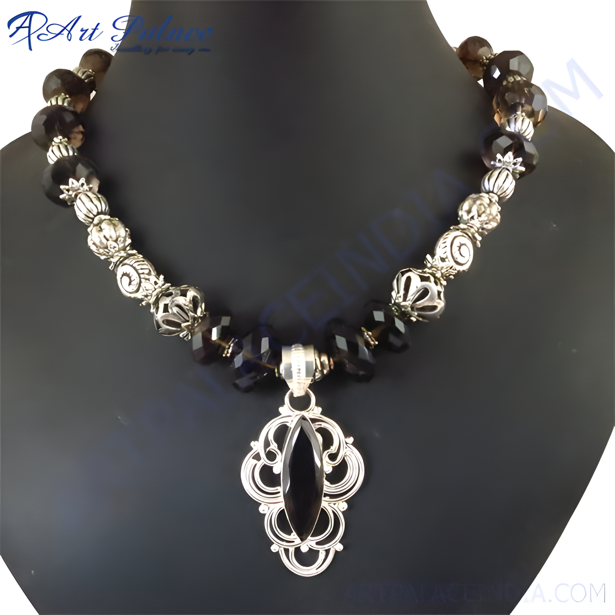 Elegant silver pendant necklace with a central black gemstone and smoky quartz beads on a black bust form