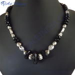 Load image into Gallery viewer, Black onyx bead necklace with sterling silver accents on a black bust
