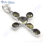 Load image into Gallery viewer, Sterling silver cross pendant with oval-cut green gemstones on white background.
