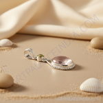 Load image into Gallery viewer, Sterling silver pendant with a large oval rose quartz gemstone and small accent stone.
