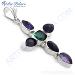 Load image into Gallery viewer, Sterling silver cross pendant necklace with a central green gemstone and surrounding purple gemstones
