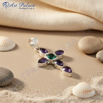 Load image into Gallery viewer, Sterling silver cross pendant necklace with a central green gemstone and surrounding purple gemstones

